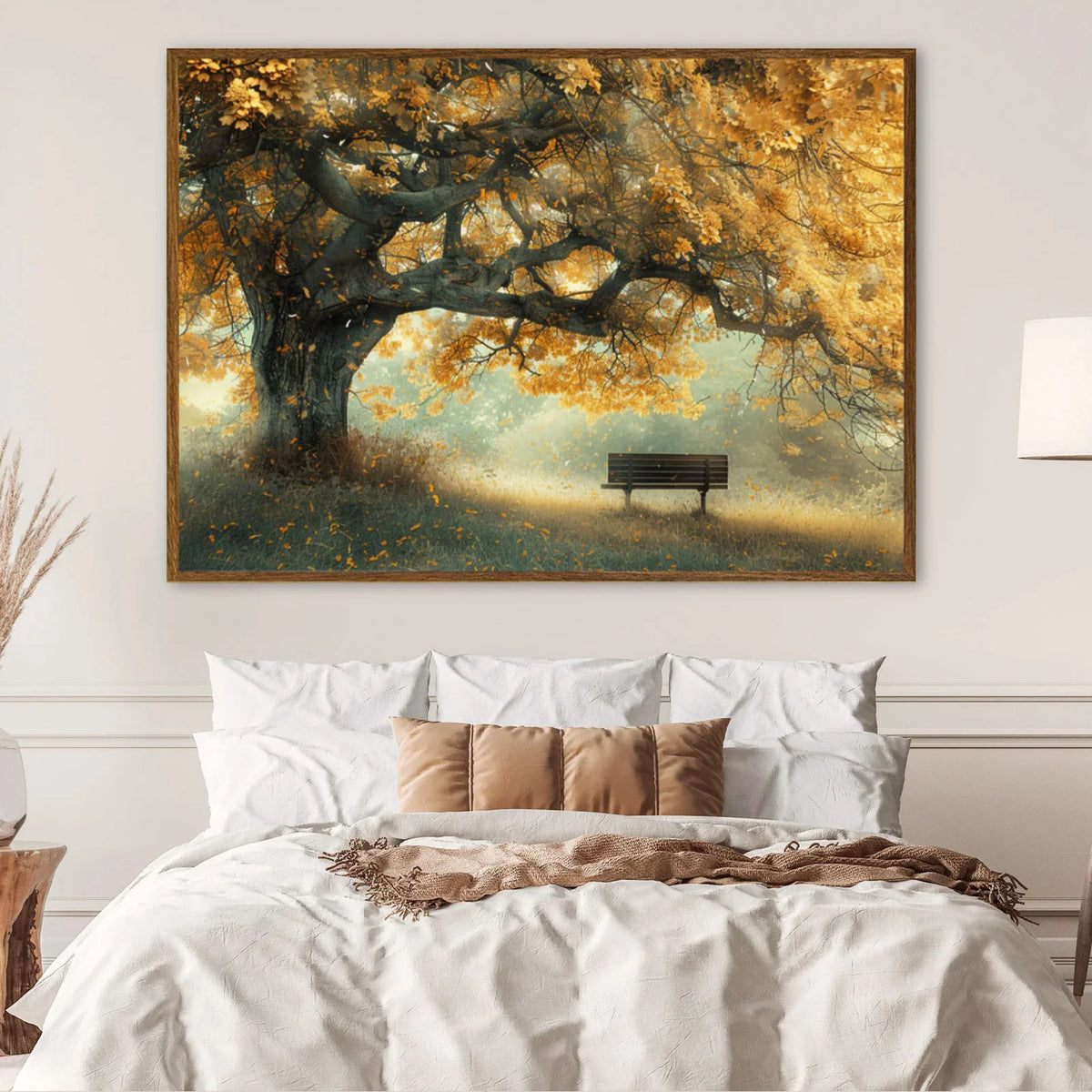 Large gnarled autumn oak tree with golden falling leaves, empty wooden park bench sits beneath sprawling branches in misty meadow